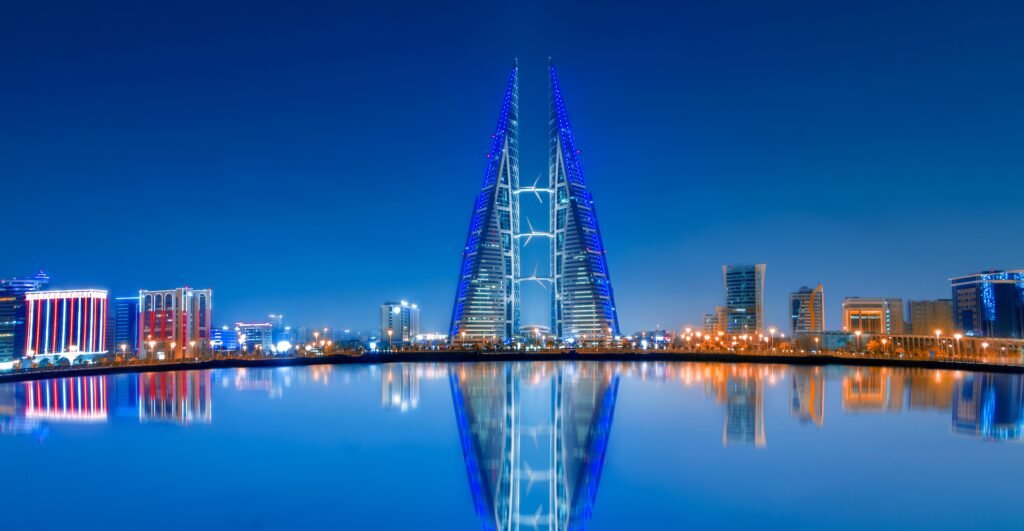 Bahrain World Trade Center illuminated at night with water reflections