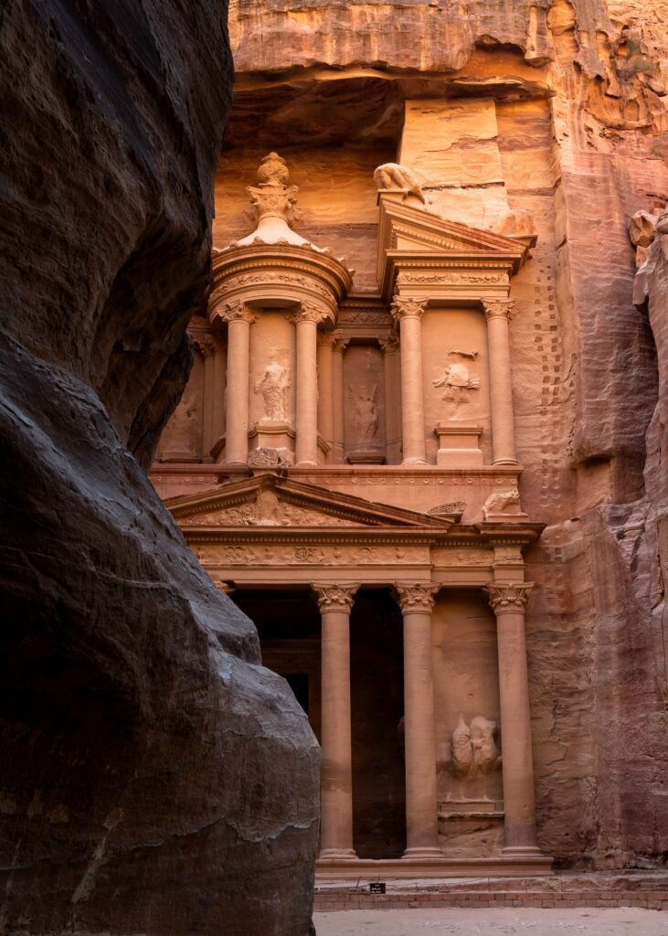 Petra's Treasury facade carved into rose-coloured sandstone