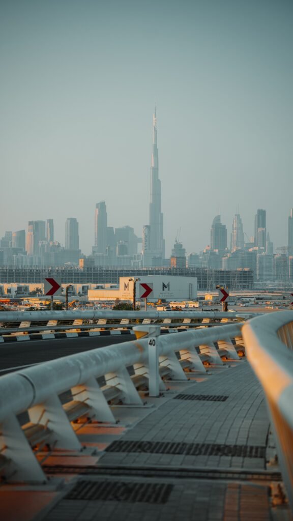 Sunrise view of the Burj Khalifa and Dubai skyline from a curved roadway